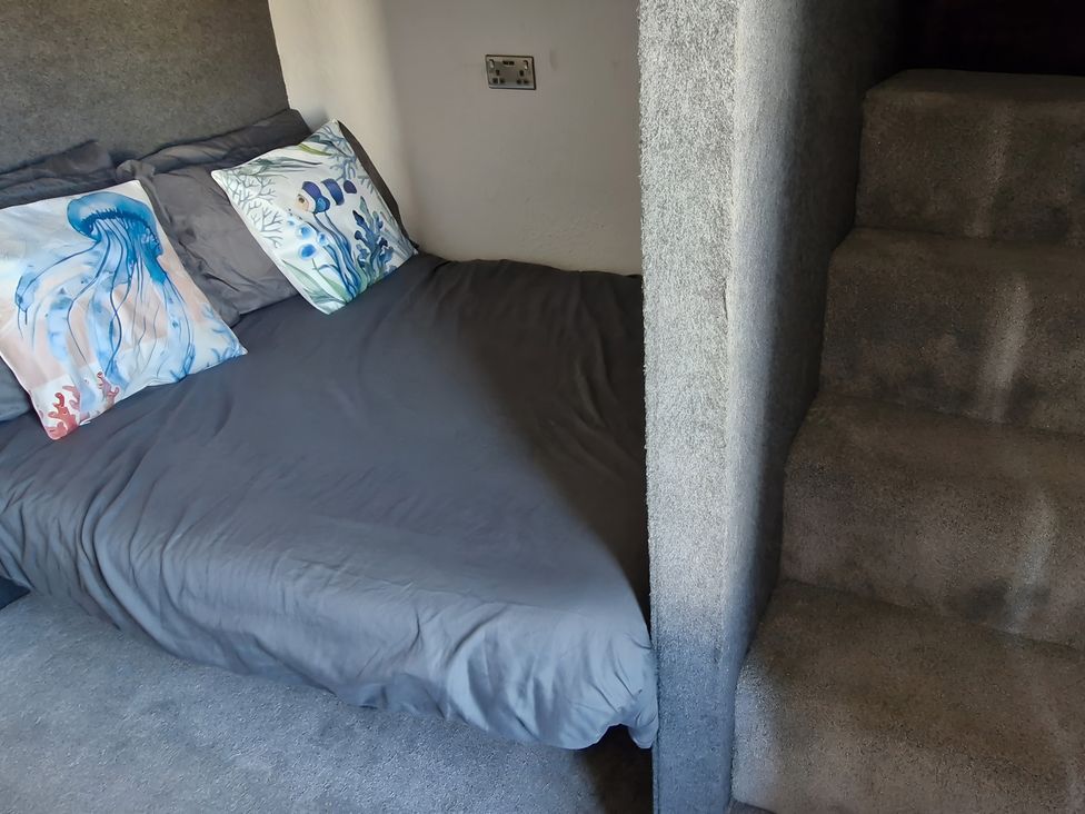 A bedroom with a bed and stairs at Waterside Lodge Mablethorpe
