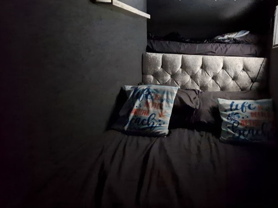 A bedroom with a bed and pillows at Waterside Lodge in Mablethorpe