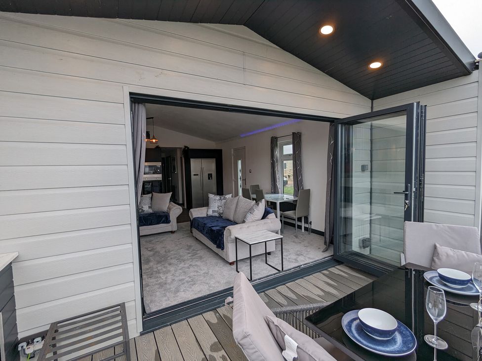A living room with sofas and dining area at Waterside Lodge in Mablethorpe