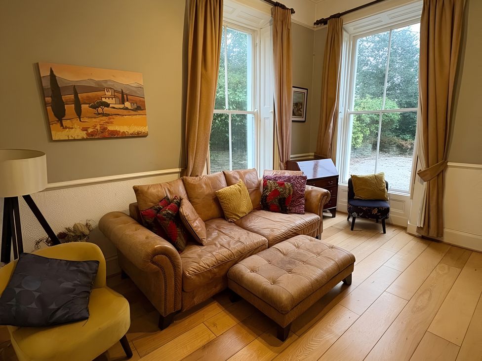 A living room with a sofa and window at Fountain Hill House Londonderry