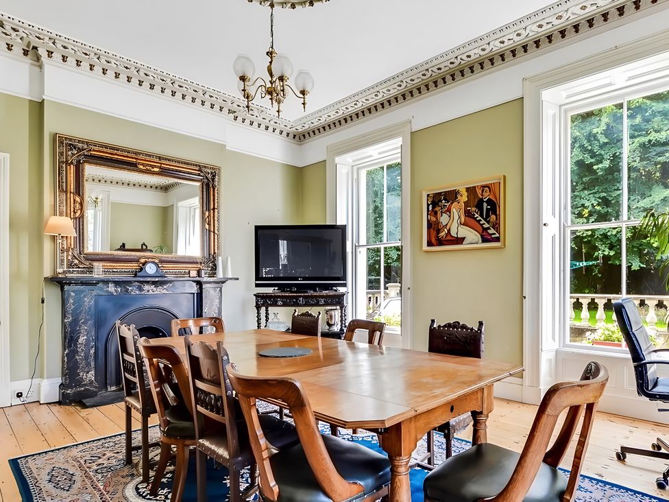 A dining room with a table and chairs at Fountain Hill House in Londonderry