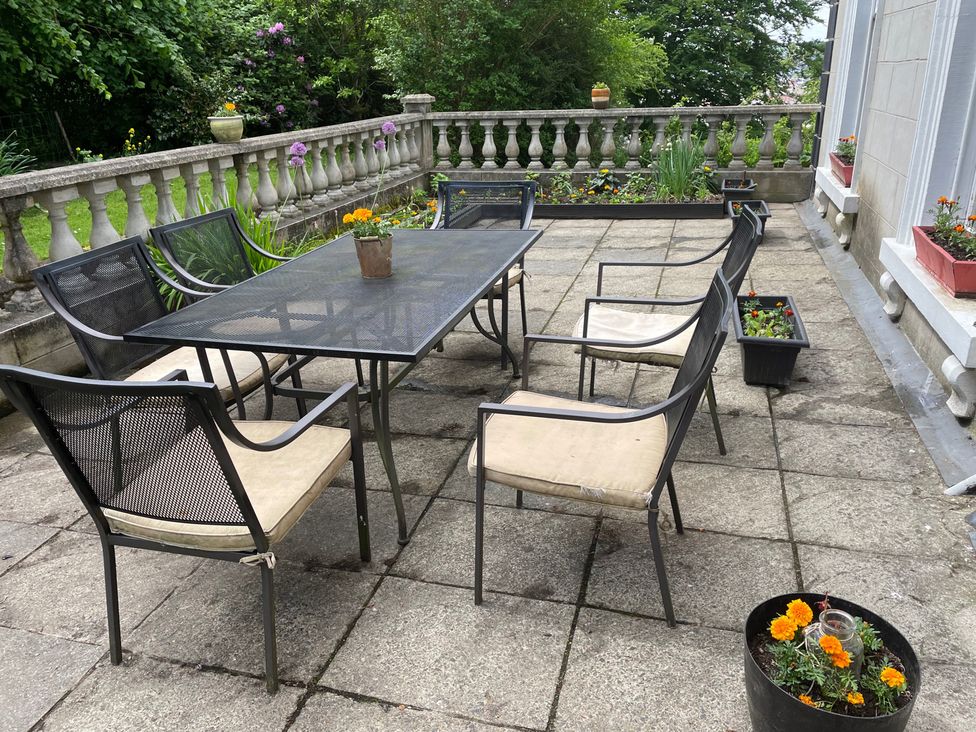 A table and chairs on a patio at Fountain Hill House in Londonderry