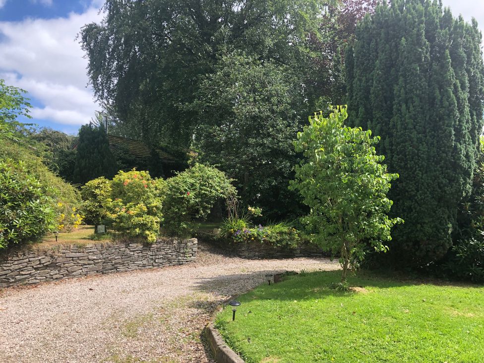 A garden with trees and a gravel pathway at Fountain Hill House Londonderry