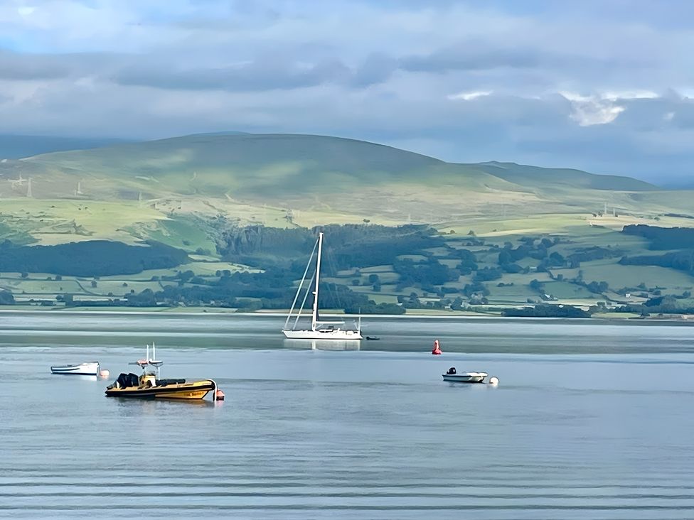 A view of boats on water with hills in the background at Bluebell Shepherd’s Hut in Llanfairpwllgwyngyll