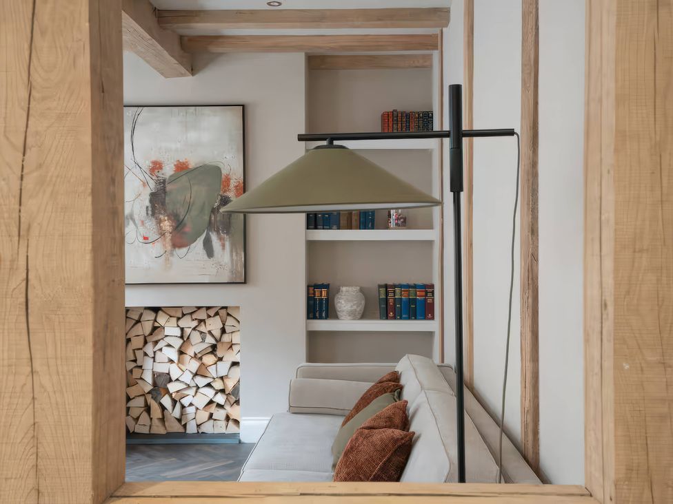A living room with a sofa and bookshelf at Apt.1 