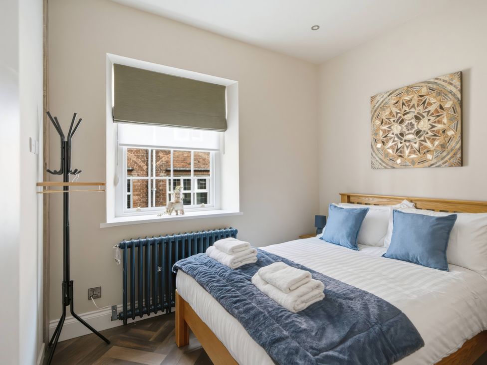 A bedroom with a bed and window at Apt.1