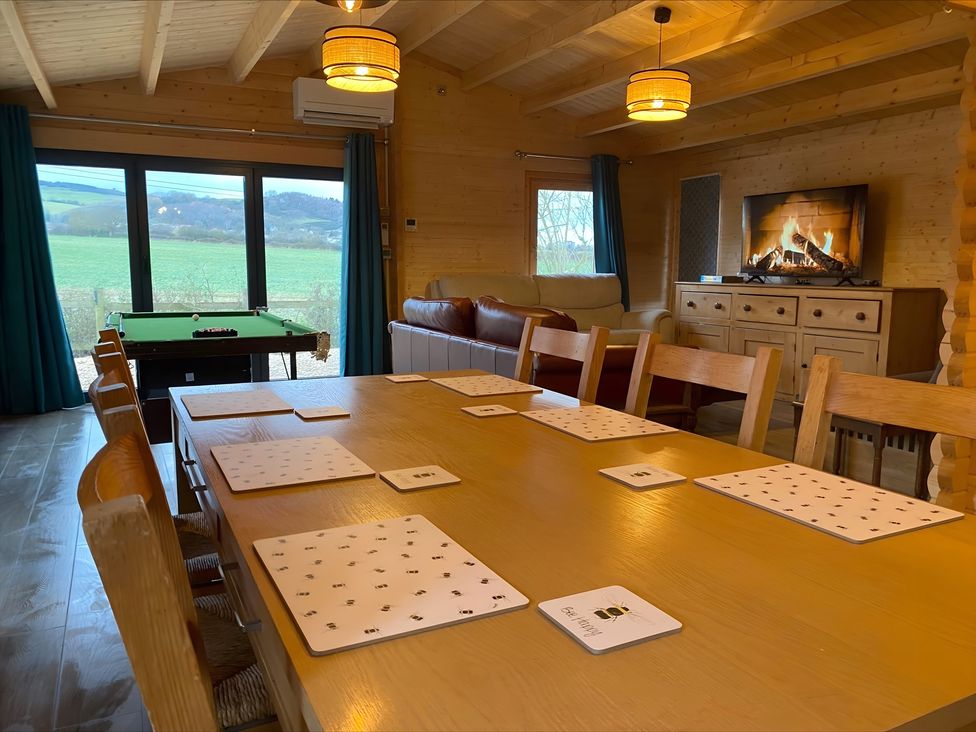 A dining room with a large table and pool table at Cotswold Nights in Evesham