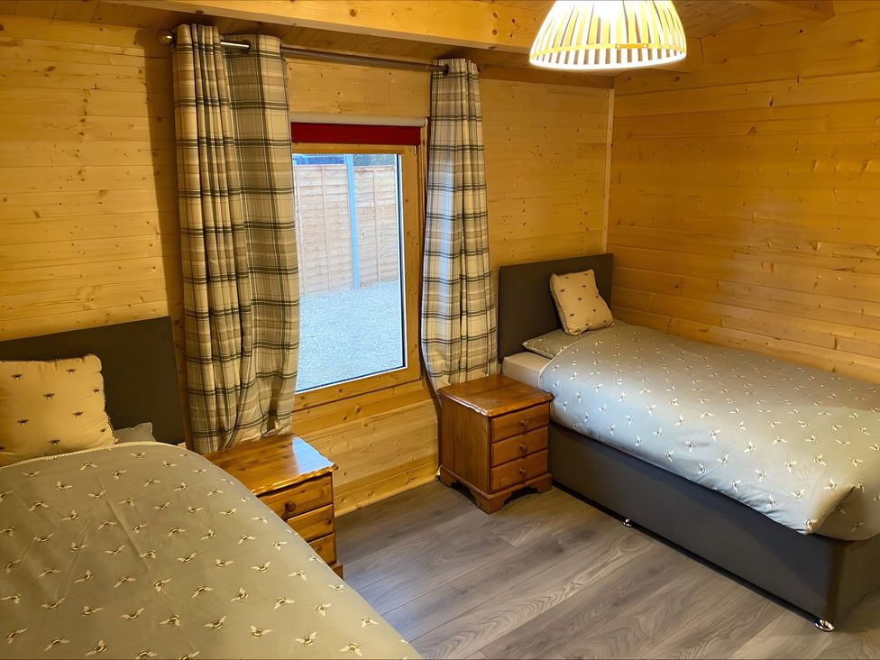 A bedroom with two beds and a window at Cotswold Nights in Evesham