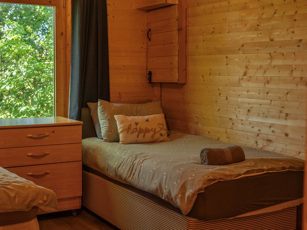 A bedroom with a bed and a window at Cotswold Nights in Ashton Under Hill