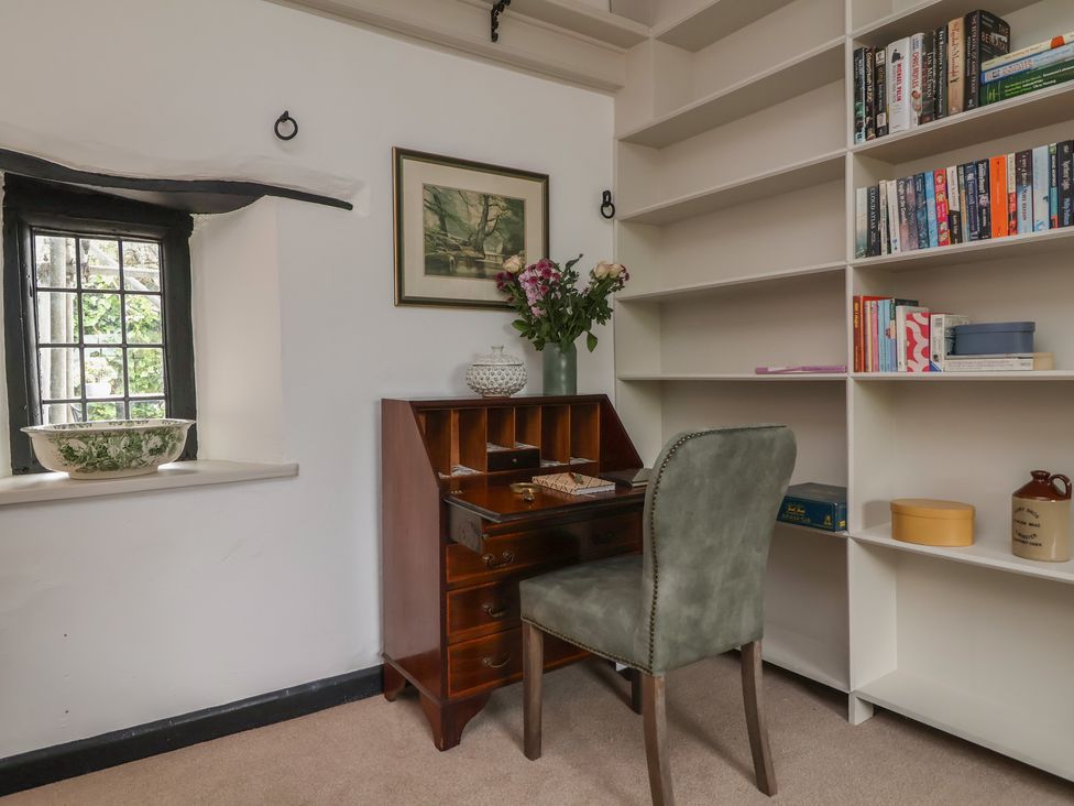 A study with a desk and bookshelf at The Olde Forge in Minehead