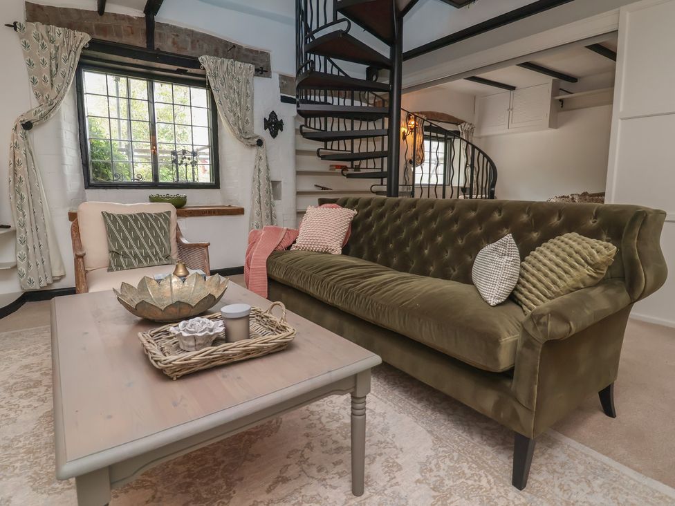 A living room with a sofa and coffee table at The Olde Forge in Minehead
