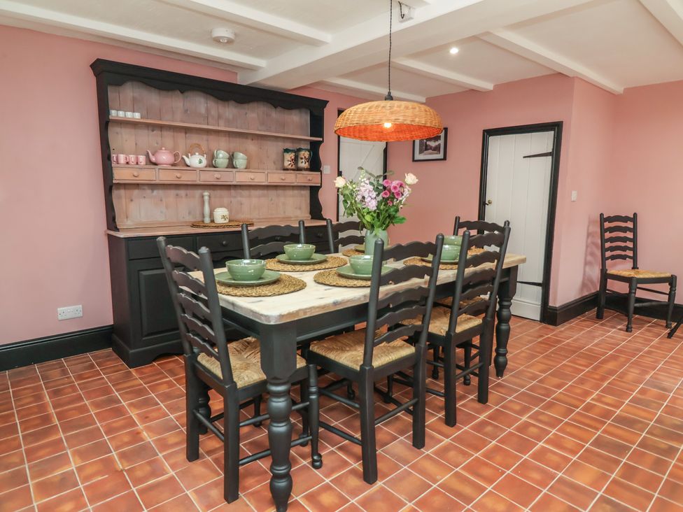 A dining room with a table and chairs at The Olde Forge in Minehead