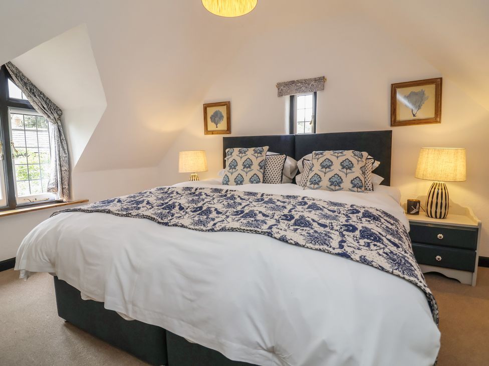 A bedroom with a bed and bedside tables at The Olde Forge in Minehead