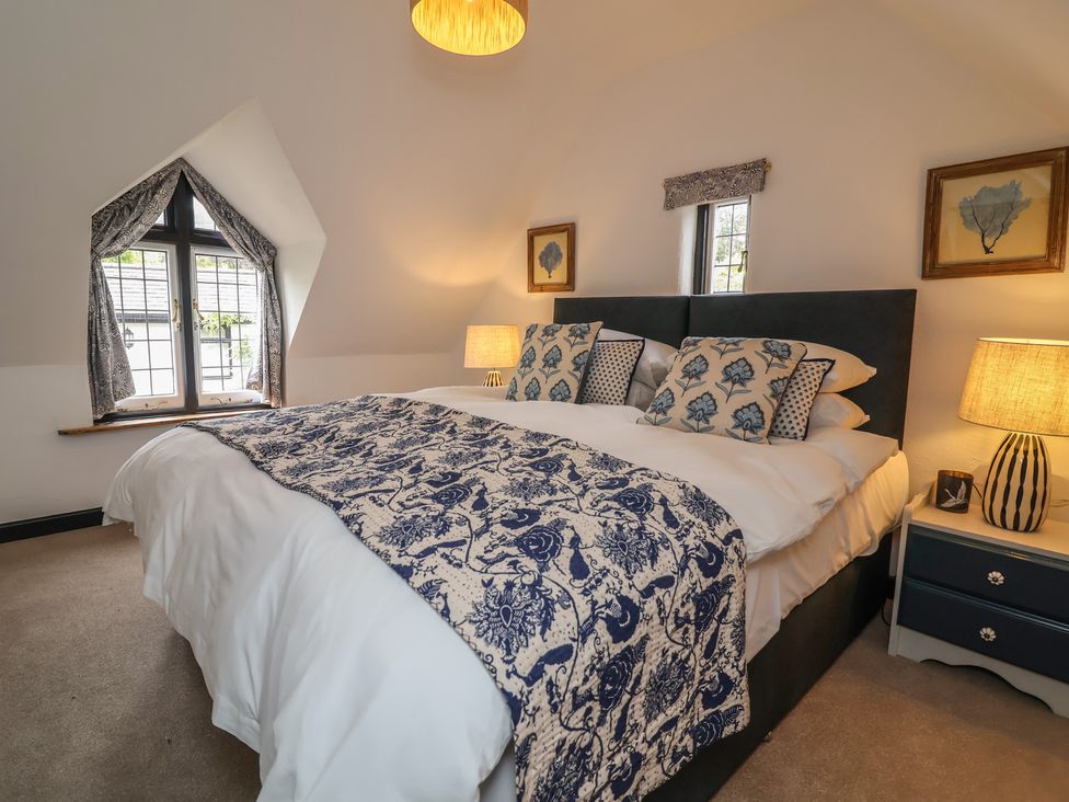 A bedroom with a double bed and two lamps at The Olde Forge in Minehead