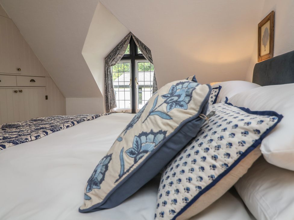 A bedroom with a bed and pillows at The Olde Forge in Minehead