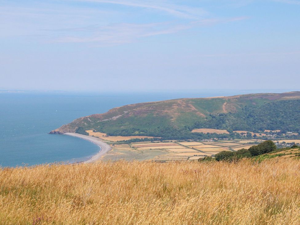 A view of the coast with fields and hills at The Olde Forge in Minehead