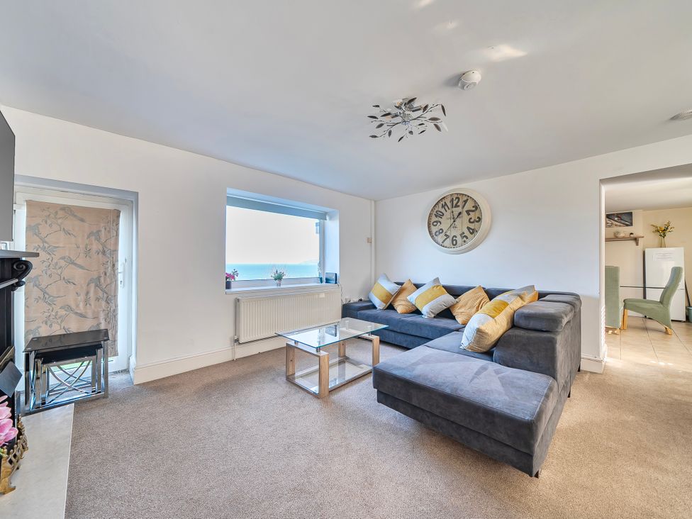 A living room with a sofa and coffee table at Sea view cottage in Penmaenmawr