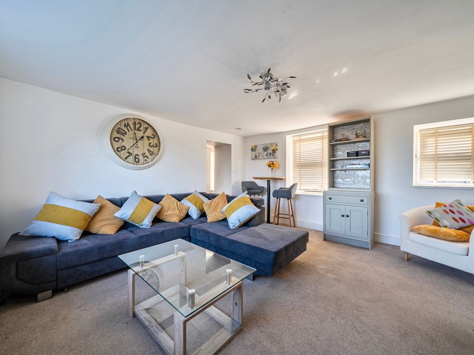 A living room with a sofa and coffee table at Sea view cottage in Penmaenmawr