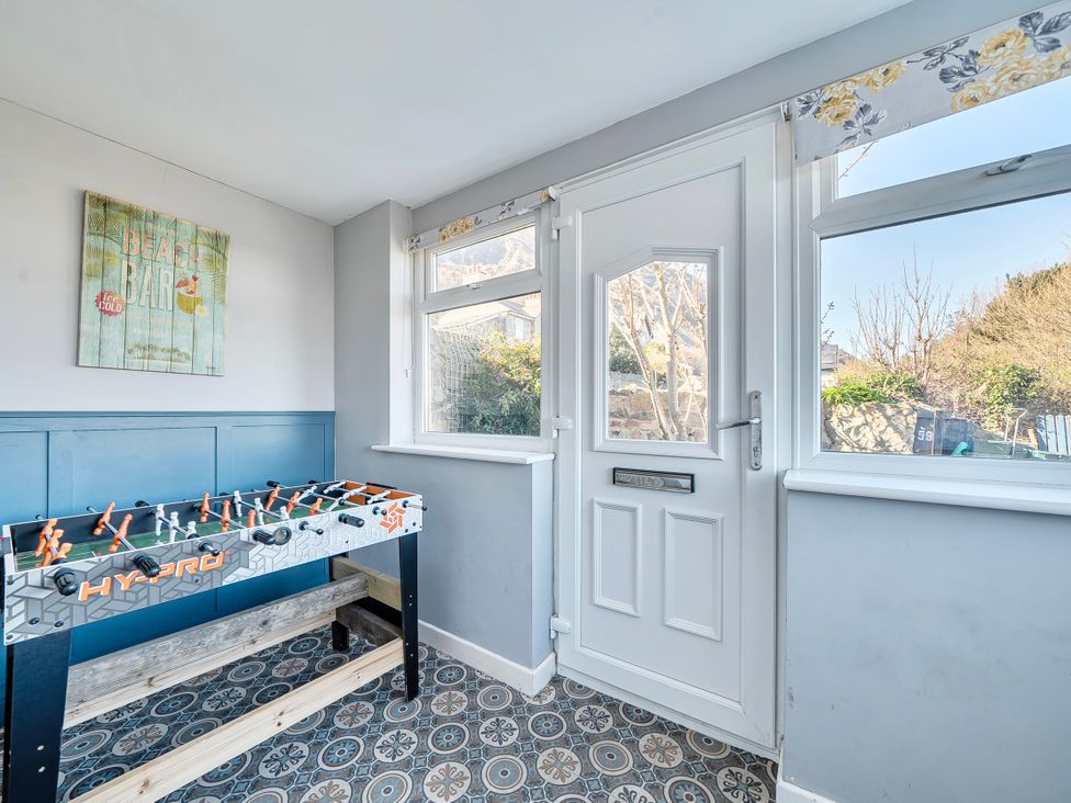 A game room with a foosball table and window at Sea view cottage Penmaenmawr