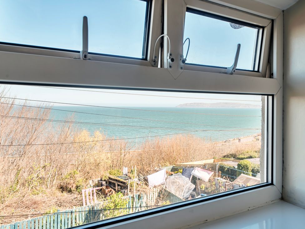 A view of the sea from a window at Sea view cottage in Penmaenmawr