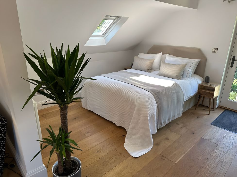 A bedroom with a bed and a plant at Hope Valley - Studio in Hope Valley
