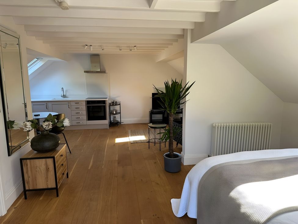 A studio with kitchen appliances and a bed at Hope Valley - Studio in Hope Valley