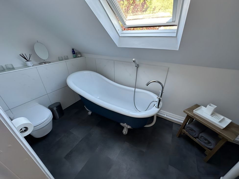 A bathroom featuring a bathtub and toilet at Hope Valley - Studio in Hope Valley