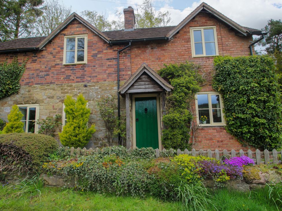 A house with a green door and garden at Cardington 25