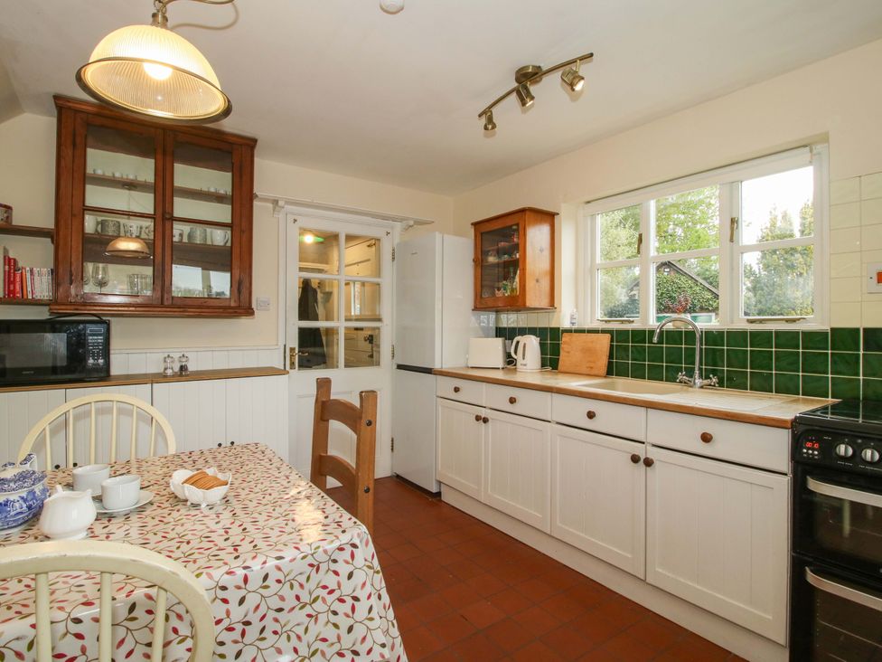 A kitchen with a table and chairs at Cardington 25