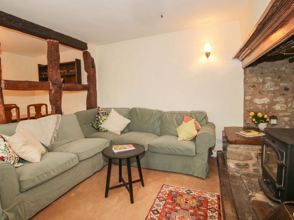 A living room with a sofa and fireplace at Cardington 25