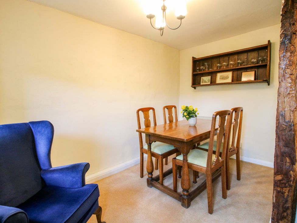 A dining room with a wooden table and chairs at Cardington 25
