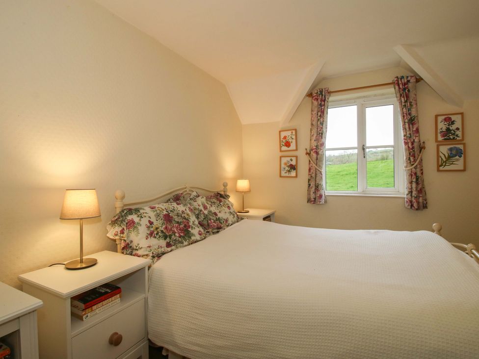 A bedroom with a bed and bedside table at Cardington 25