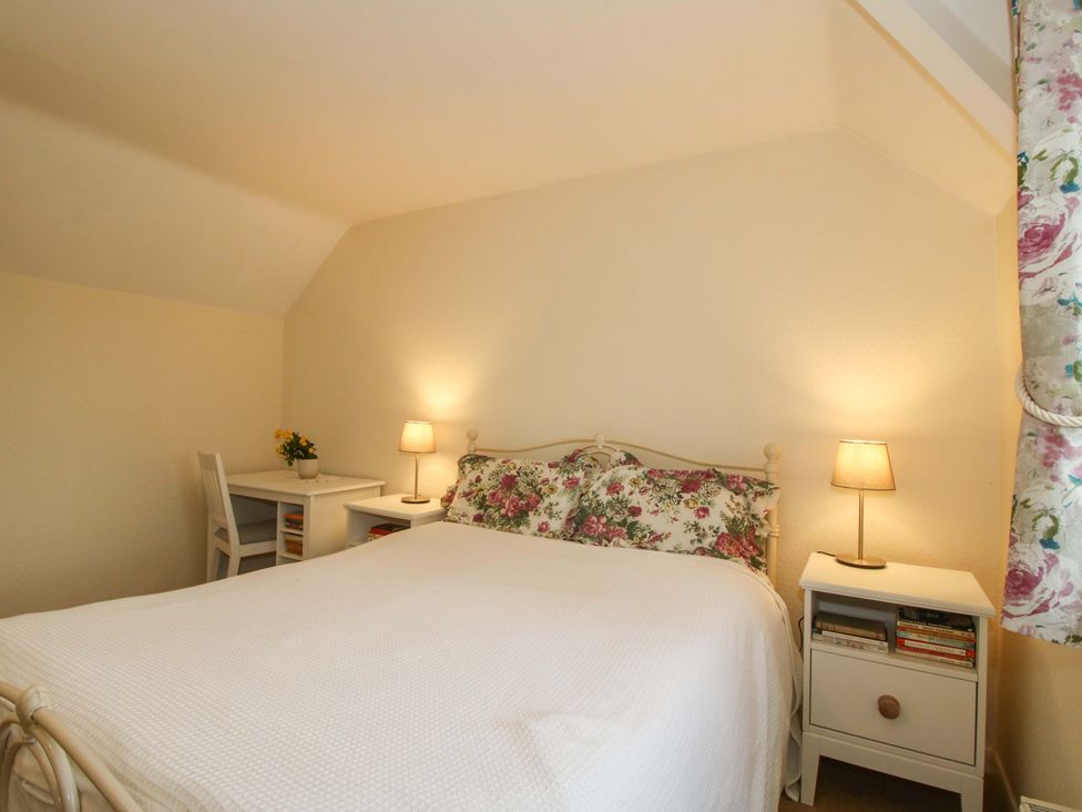 A bedroom with a bed and a desk at Cardington 25