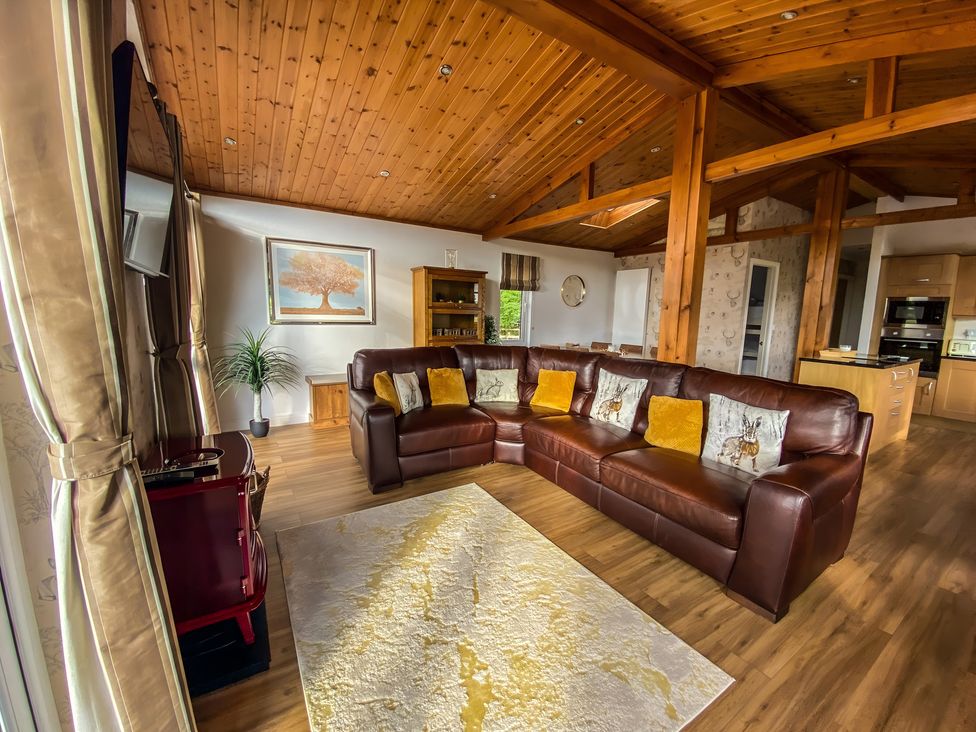 A living room with a sofa and rug at Hedgehog Lodge in York
