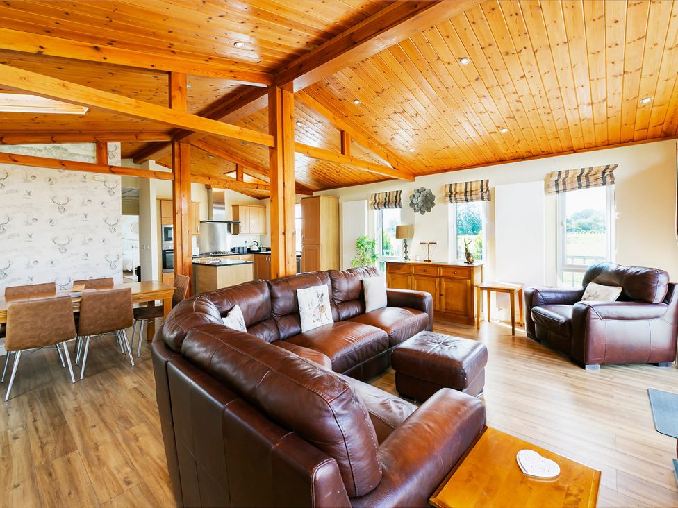 A living room with sofas and a dining area at Hedgehog Lodge in York