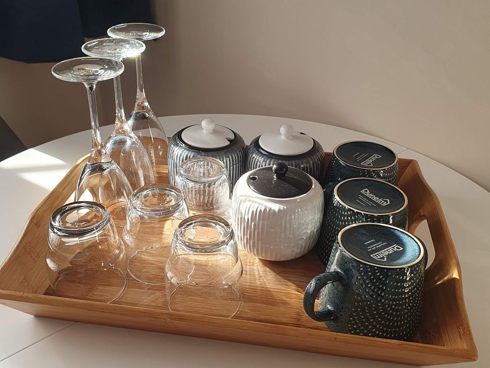 A collection of glassware and ceramic mugs on a tray in Kinamara Ensuite Room