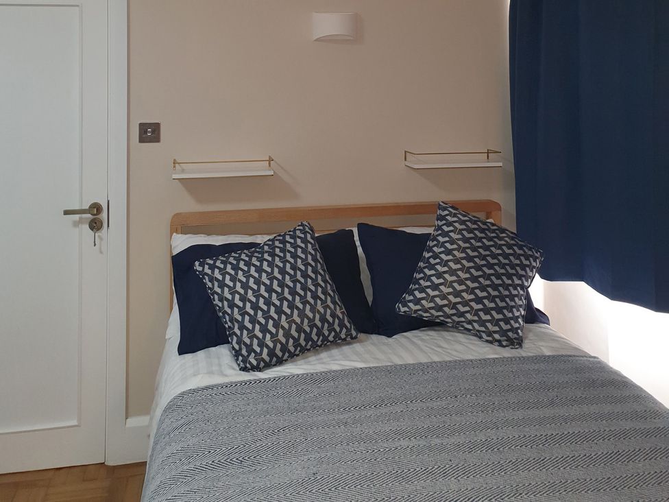 A bedroom with a bed and pillows at Kinamara Ensuite Room 
