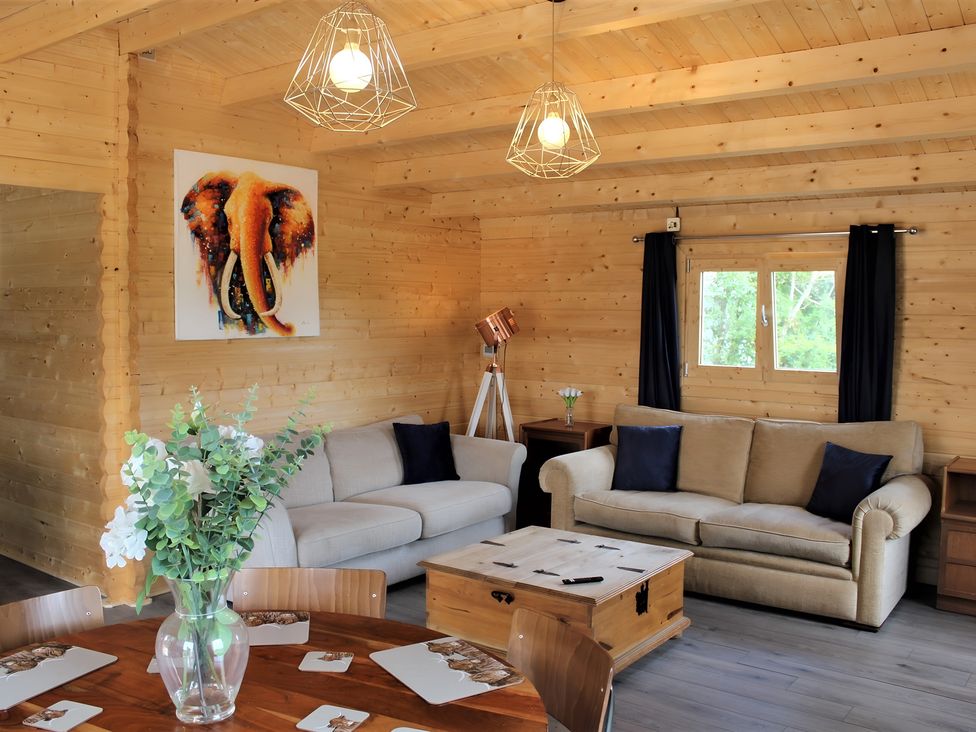 A living room with a sofa and coffee table at Cotswold Nights Away in Evesham