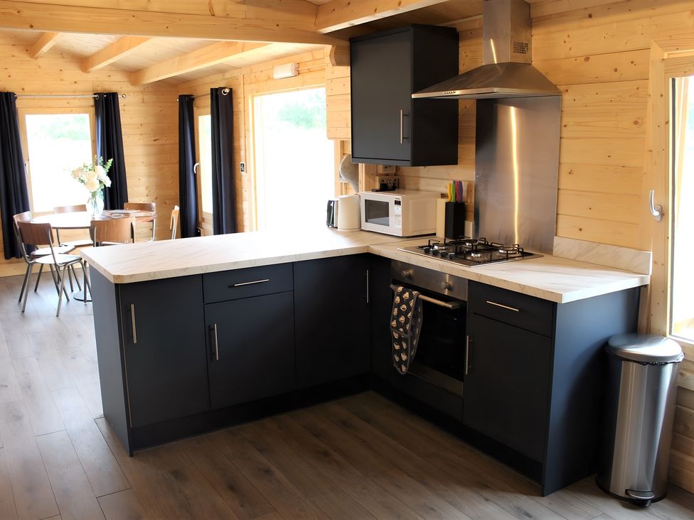 A kitchen with cabinets and appliances at Cotswold Nights Away in Evesham