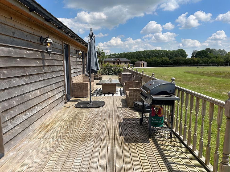 An outdoor space with a patio table and seating at Fox Lodge in York
