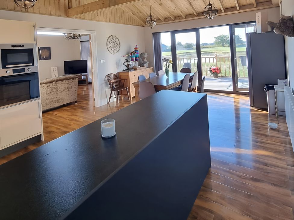 A kitchen with a large island and dining area at Fox Lodge in York
