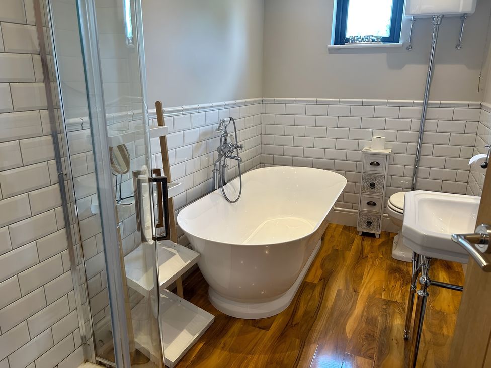 A bathroom with a bathtub and shower at Fox Lodge in York