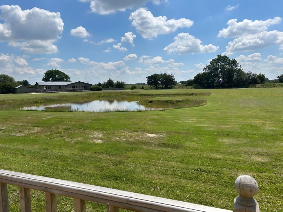 An outdoor view of a house and pond at Fox Lodge in York