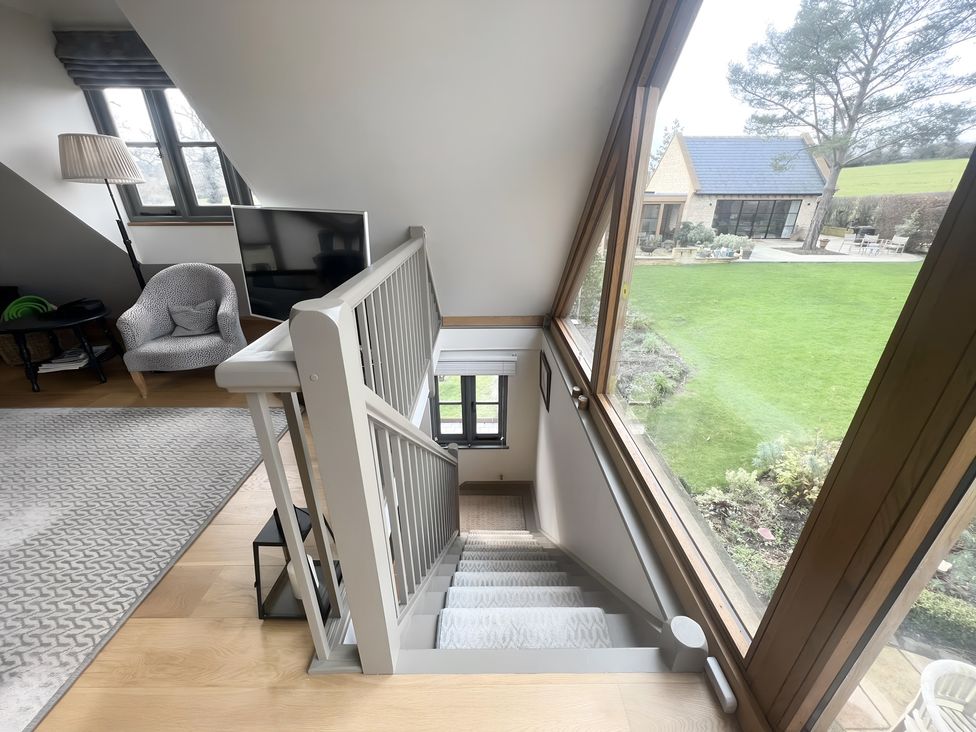 A staircase leading down with a garden view at Christmas Cottage in Shipston-on-Stour