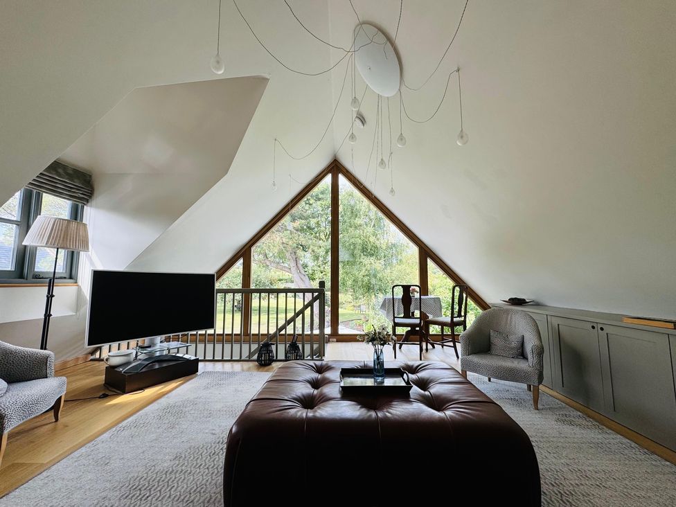 A living room with a television and sofa at Christmas Cottage in Shipston-on-Stour