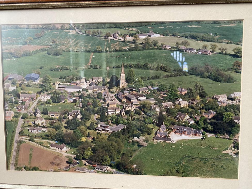An aerial view of a village with houses and a church at Christmas Cottage in Shipston-on-Stour