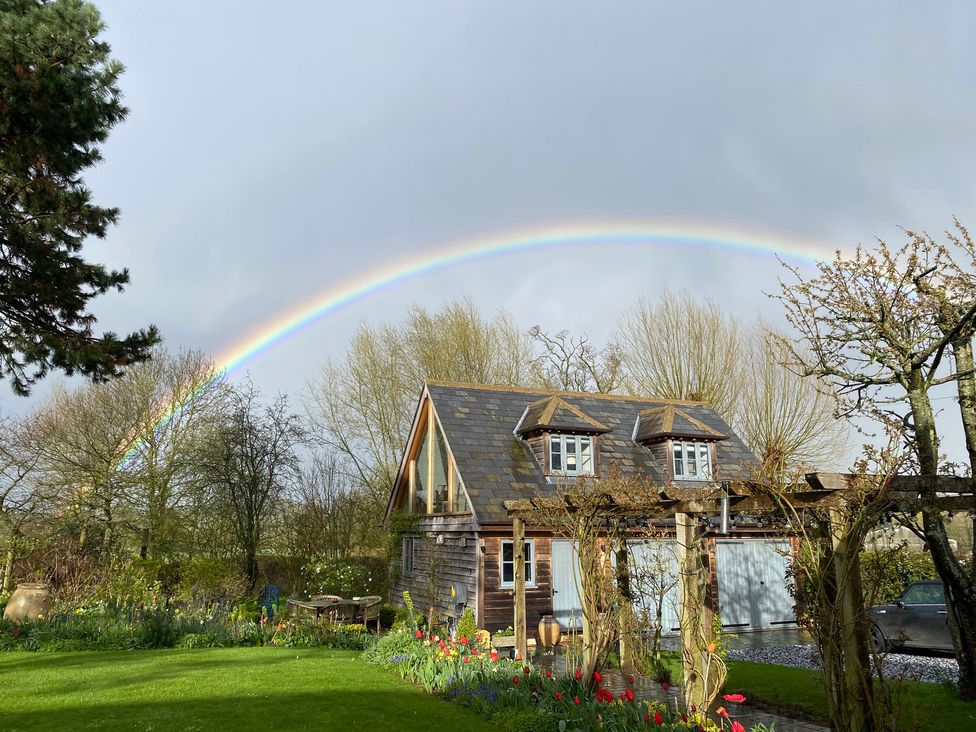 An outdoor view of a building with a rainbow at Christmas Cottage in Shipston-on-Stour
