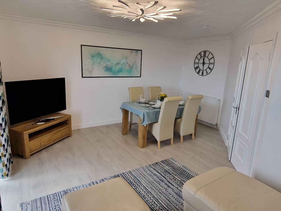 A dining room with a table set for dinner at 36 Deas Wharf in Kirkcaldy