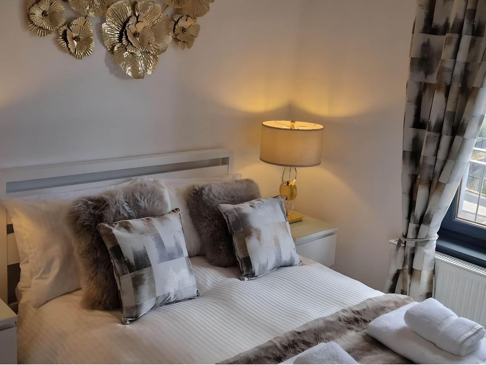 A bedroom with a bed and decorative items at 36 Deas Wharf in Kirkcaldy