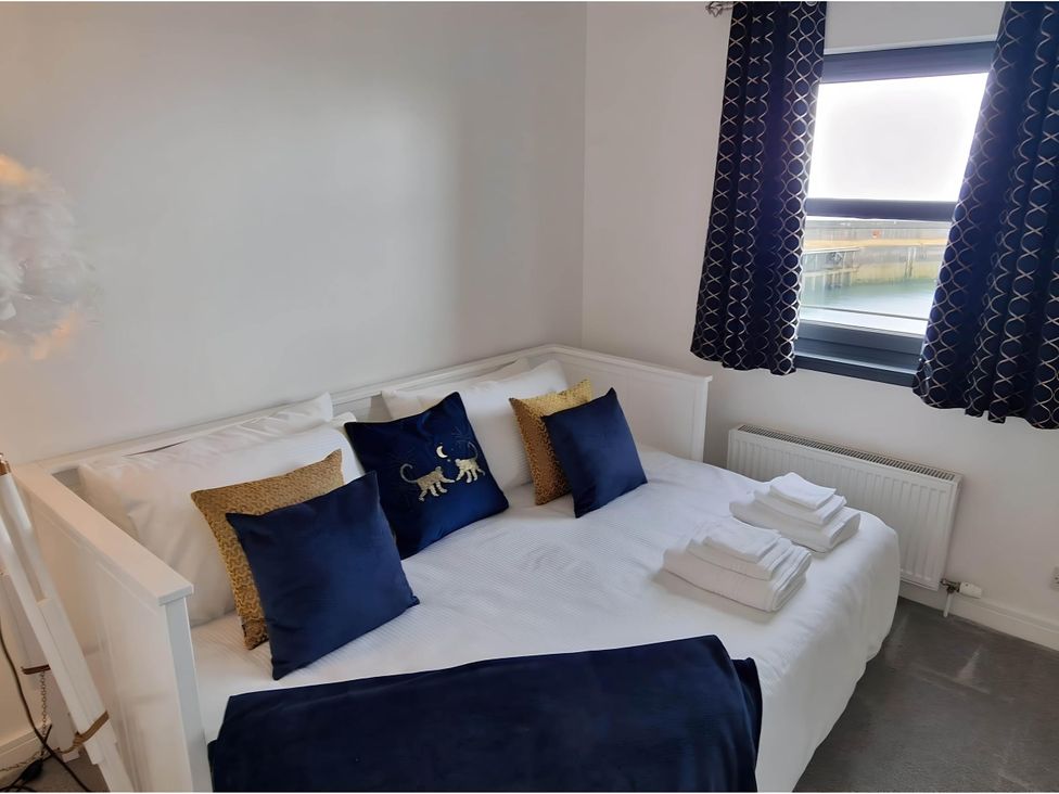 A bedroom with a bed and pillows at 36 Deas' Wharf in Kirkcaldy